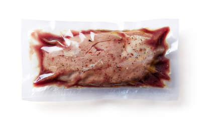 Duck breast vacuum sealed isolated on white, from above