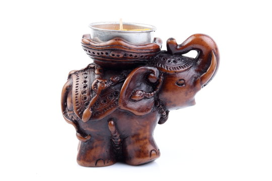 Brown elephant made of resin like wooden carving with candle holder with white ivory. Stand on white background, Isolated, Art Model Thai Crafts, For decoration Like in the spa.