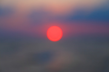 Landscape sunset over the sea in defocusing effect, looks like an abstract background.