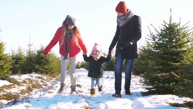 Parents with child running in forest