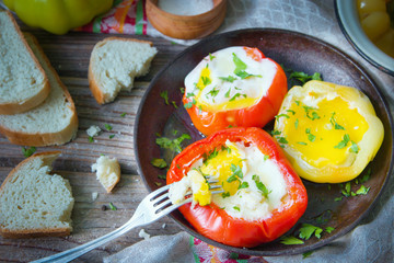 Tasty dish with fried eggs in yellow and red bell peppers.