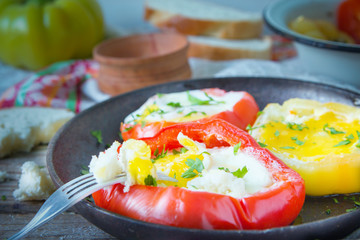 Tasty dish with fried eggs in yellow and red bell peppers.