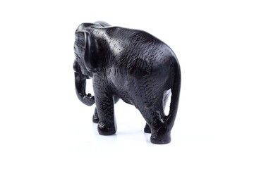 Black elephant like wooden carving with white ivory. Stand on white background, Isolated, Art Model Thai Crafts, For decoration Like in the spa.