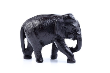 Black elephant like wooden carving with white ivory. Stand on white background, Isolated, Art Model Thai Crafts, For decoration Like in the spa.