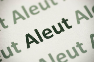 word Aleut language printed on paper macro