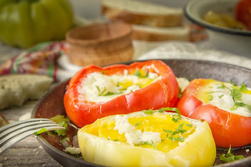 Delicious dish with fried eggs in yellow and red bell pepper