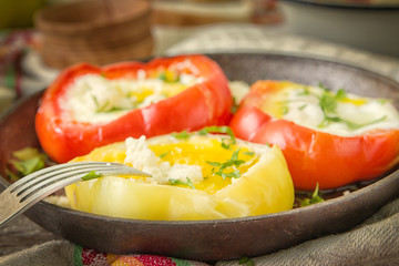Delicious dish with fried eggs in yellow and red bell pepper