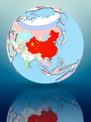 China on political globe with flags
