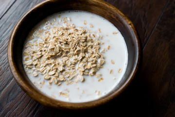 Oatmeal with Milk in Wooden Bowl / Plain Porridge