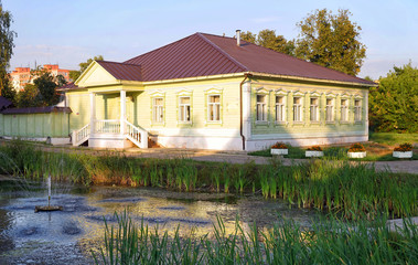 Traditional Russian wooden house on the shore of a pond. in Dmitrov, Russia.