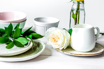 ceramic tableware with flowers on white background