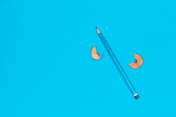 Blue Pencil and Shavings on a Blue Background