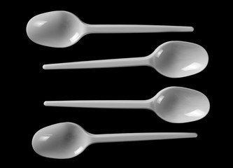 set plastic white spoon isolated on black background, top view, clipping path
