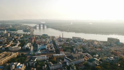 Aerial Video footage Kiev Kyiv Ukraine. Podil historical city center. Down town. River and bridge. Sunrise backlight