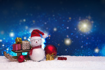 Naklejka na ściany i meble Snowman with Christmas gifts and star sky. New Year background.
