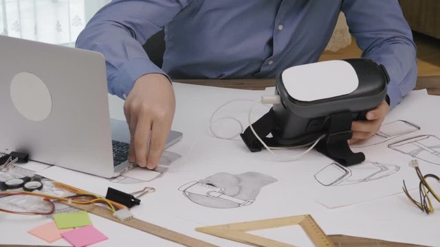 Software engineer programming VR headset