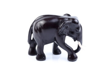 Black elephant like wooden carved with white ivory. Stand on white background, Isolated, Art Model Thai Crafts, For decoration Like in the spa.