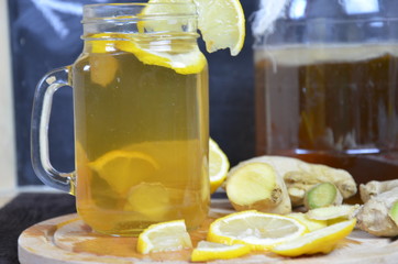 Homemade fermented raw kombucha tea with different flavorings. Healthy natural probiotic flavored drink with lemon and ginger or ginger ale. Copy space.