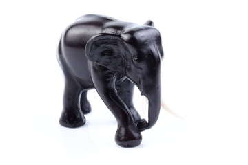 Black elephant like wooden carved with white ivory. Stand on white background, Isolated, Art Model Thai Crafts, For decoration Like in the spa.