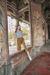 elegant asian woman stepping in Longshan Temple.