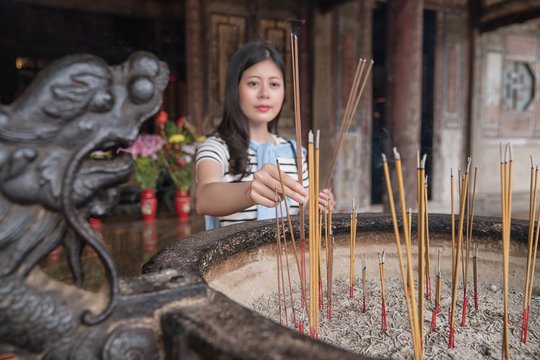 believer putting incense into censer.