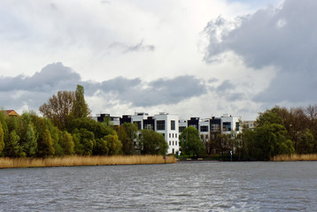 Fototapeta na wymiar View of river and beautiful white and black houses, modern architecture, sleeping quarters, Berlin, Germany