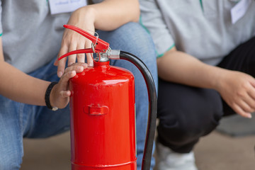 Instructor showing how to use a fire extinguisher on a training fire