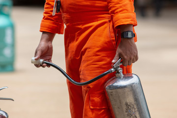 2018 Aug 7, Lampang, Thailand, Instructor showing how to use a fire extinguisher on a training fire