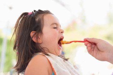 Cute little girl eating puree