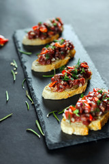 bruschetta on a black background