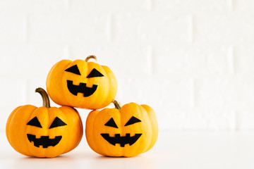 yellow ghost pumpkin on white brick block background. halloween concept.