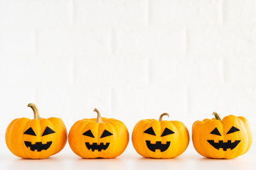 yellow ghost pumpkin on white brick block background. halloween concept.