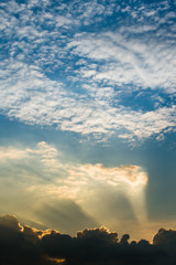 Sun rays through clouds like an dramatic explosion , power nature background.