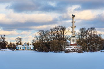 Fototapeta na wymiar Chesme Column on frozen big pond in Catherine park at Tsarskoe Selo in winter. Pushkin. Saint Petersburg. Russia