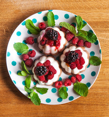 Curd-chocolate dessert without sugar with fresh raspberries, blackberry and mint. Healthy eating. The concept of a healthy diet.