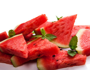 Watermelon slices and mint leaves on white backgroung. Healthy vegetarian food