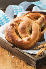 Homemade salted pretzels for Oktoberfest on old  wooden board  with free text space.