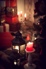 Christmas gifts and candles in lanterns