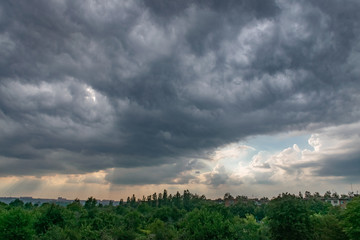 Obraz premium A dark gray clouds hovered over the city. Sunset.