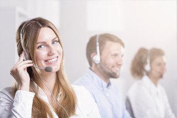 Smiling woman with headset during customer service in call center