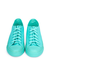 Turquoise rubber sneakers, casual footwear isolated on white background, copy space template