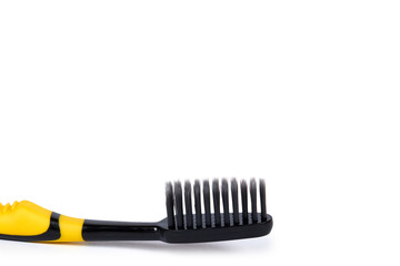 Black and yellow soft toothbrush isolated on white background, copy space template