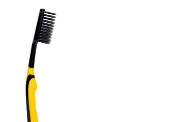 Black and yellow soft toothbrush isolated on white background, copy space template