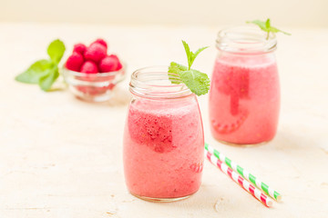 Raspberry smoothie close up photography with fresh summer blended cocktail and ripe berries.