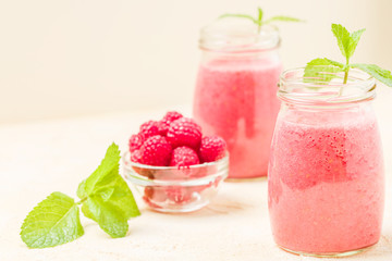 Raspberry smoothie close up photography with fresh summer blended cocktail and ripe berries.