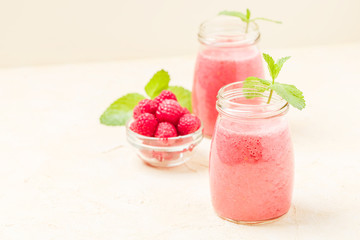 Raspberry smoothie close up photography with fresh summer blended cocktail and ripe berries.