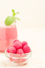 Raspberry smoothie close up photography with fresh summer blended cocktail and ripe berries.