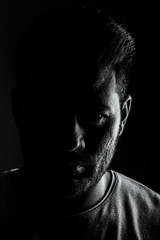 Indian man low key black and white portrait.