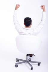 Businessman sitting on white chair isolated.
