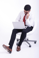 Businessman sitting on white chair isolated.